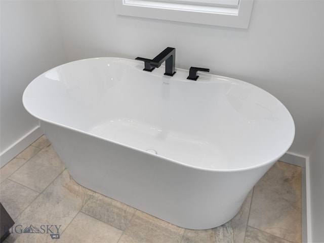 2820 S 30th Ave, Bozeman, MT 59718 - bathroom view of a freestanding tub, baseboards, and a sink