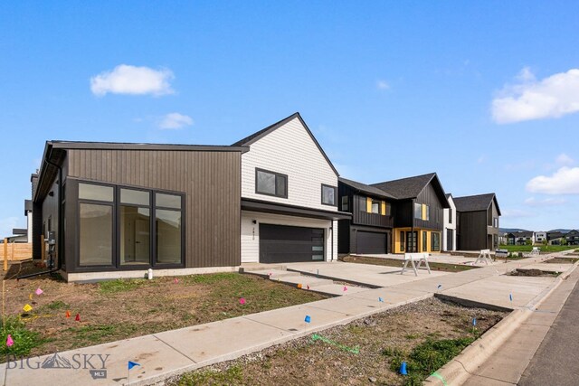 2820 S 30th Ave, Bozeman, MT 59718 - view of front facade with a garage, concrete driveway, and a residential view