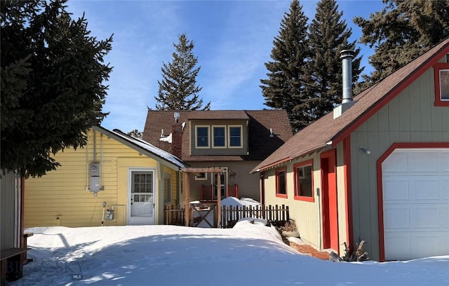 exterior space featuring a garage and fence