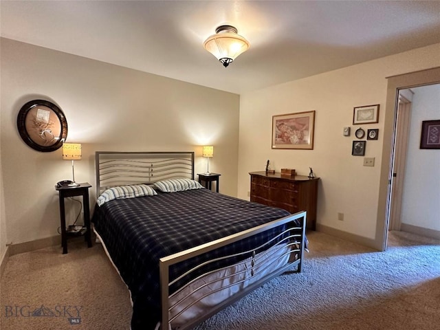 bedroom with carpet and baseboards