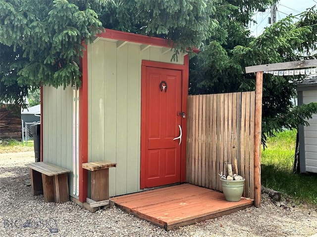 view of shed featuring fence