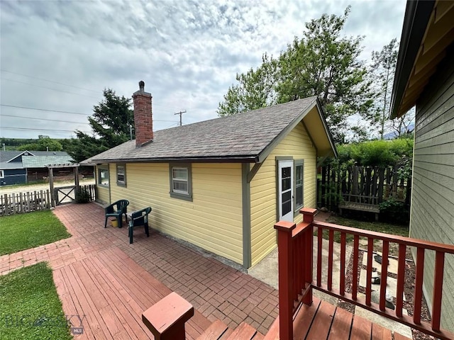 wooden deck with a patio area and fence