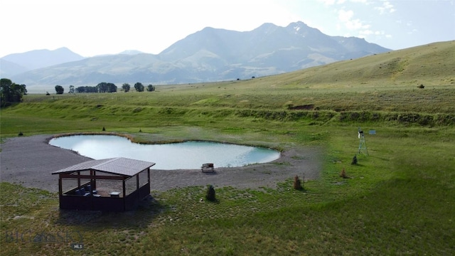 surrounding community featuring a water and mountain view