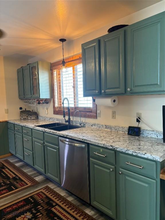 kitchen featuring a sink, dishwasher, and decorative light fixtures