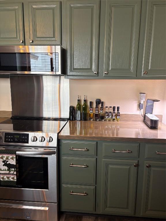 kitchen featuring green cabinets and stainless steel appliances