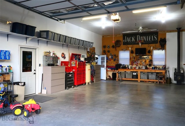 garage featuring a garage door opener and a workshop area