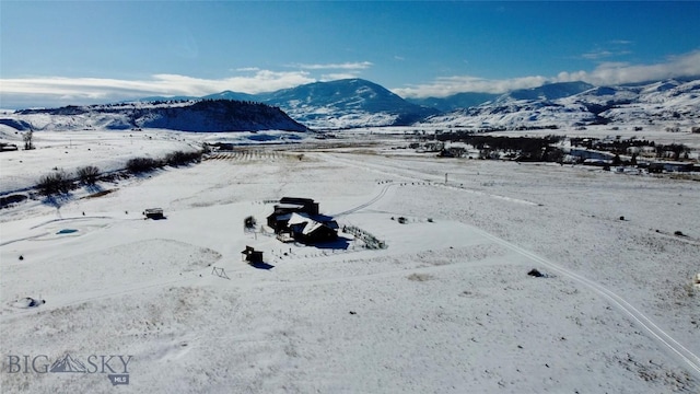 snowy aerial view with a mountain view