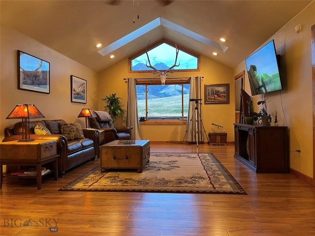 living room featuring vaulted ceiling with skylight, baseboards, wood finished floors, and recessed lighting