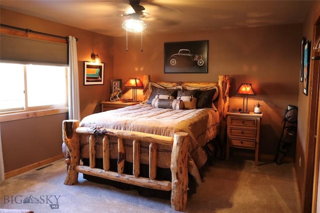 bedroom with baseboards, carpet flooring, visible vents, and a ceiling fan