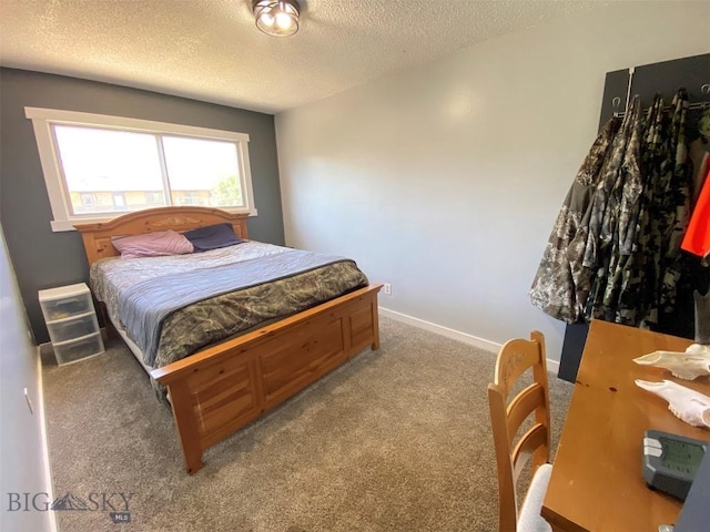 carpeted bedroom with a textured ceiling and baseboards