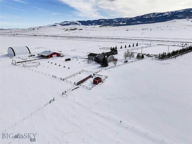 snowy aerial view featuring a mountain view