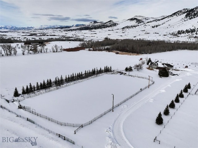 snowy aerial view with a mountain view