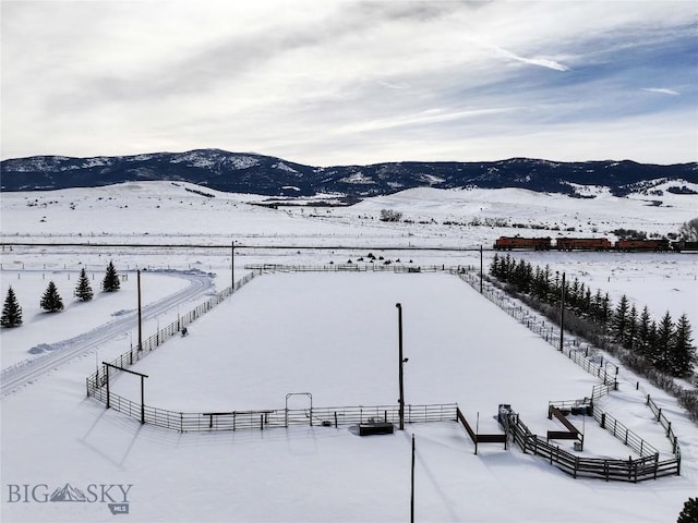 snowy aerial view featuring a mountain view