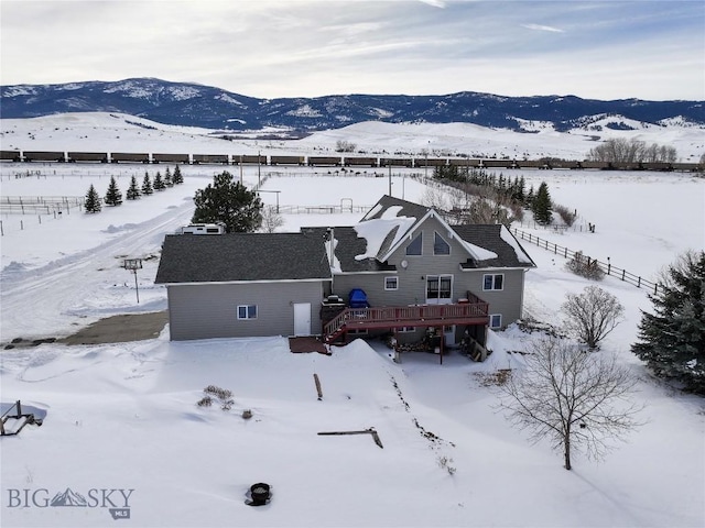 snowy aerial view with a mountain view