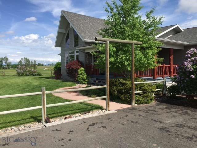 view of play area featuring a yard, fence, and a wooden deck