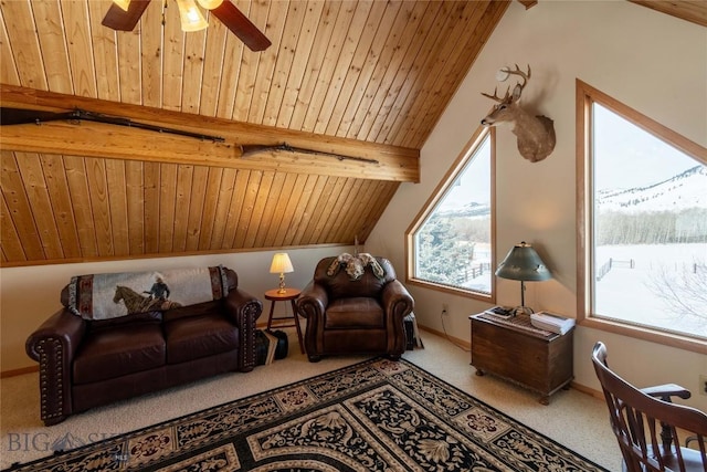 carpeted living area with lofted ceiling with beams, wooden ceiling, ceiling fan, and baseboards