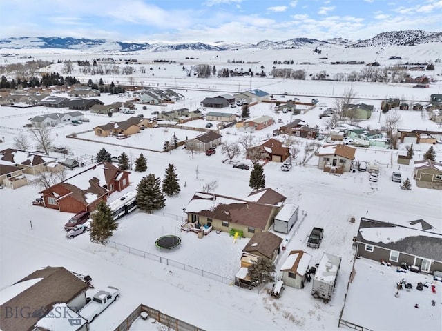 snowy aerial view with a residential view and a mountain view