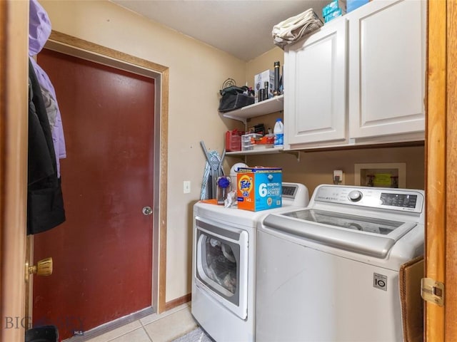laundry room featuring separate washer and dryer, light tile patterned flooring, and cabinet space