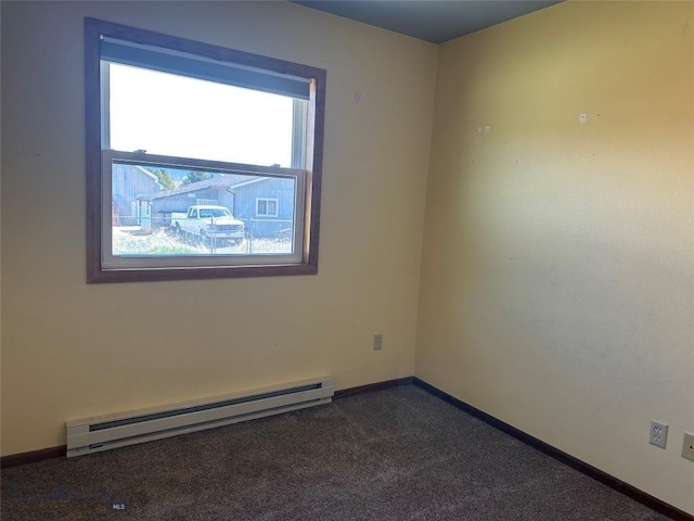 unfurnished room with baseboards, a baseboard radiator, and dark carpet