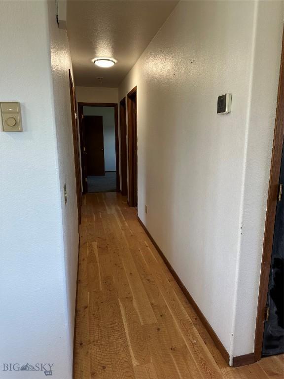 727 Mirza Way, Ennis, MT 59729 - corridor featuring light wood finished floors and baseboards