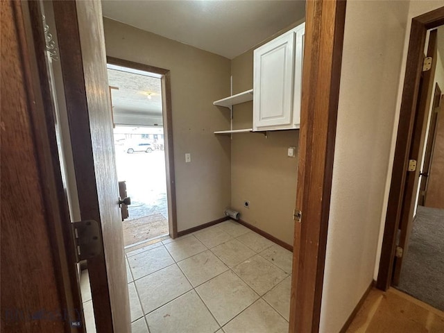 727 Mirza Way, Ennis, MT 59729 - laundry room with hookup for an electric dryer, cabinet space, and light tile patterned floors