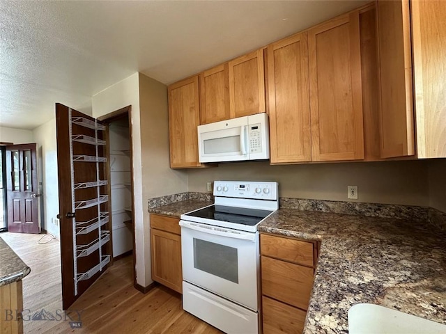 727 Mirza Way, Ennis, MT 59729 - kitchen featuring white appliances, light wood-type flooring, and a textured ceiling