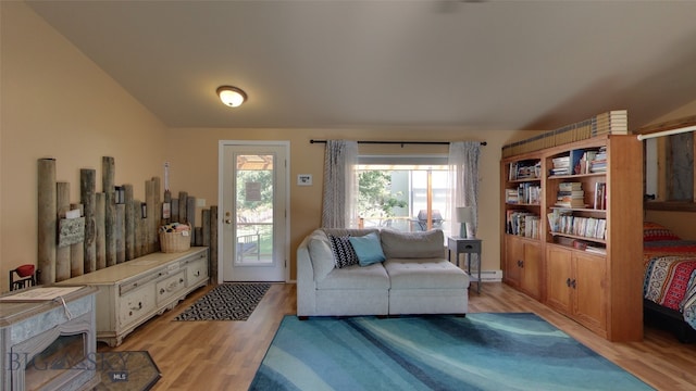 interior space with a baseboard heating unit and light wood-type flooring