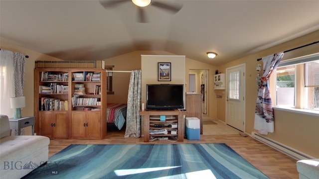 living area with ceiling fan, light wood-style flooring, vaulted ceiling, and baseboard heating