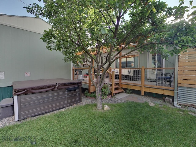 view of yard featuring a hot tub and a deck