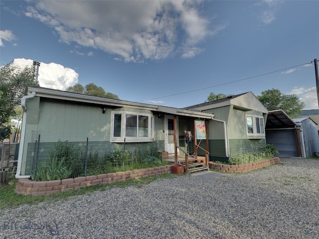 view of front of house with brick siding and an outdoor structure