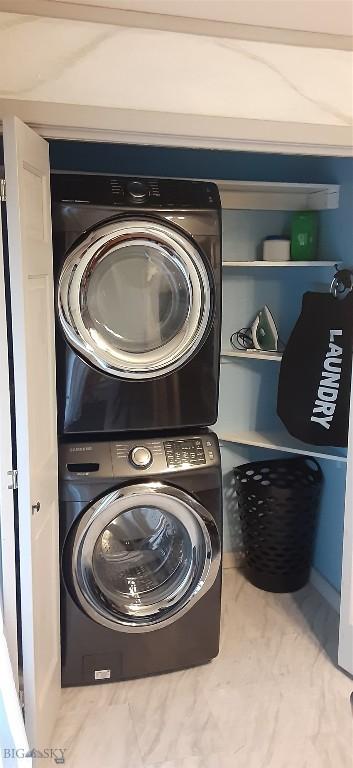 clothes washing area with laundry area and stacked washer / drying machine