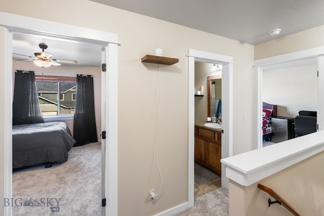 84 Tail Feather Ln Unit B, Bozeman, MT 59718 - hallway with light colored carpet and a sink