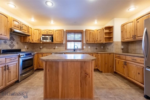 2212 Sourdough Rd, Bozeman, MT 59715 - kitchen with appliances with stainless steel finishes, under cabinet range hood, a sink, a kitchen island, and backsplash