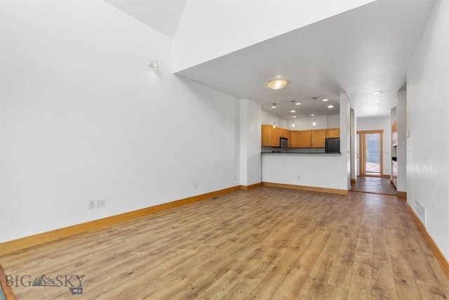 1281 Stoneridge Unit A, Bozeman, MT 59718 - unfurnished living room featuring light wood-style flooring and baseboards