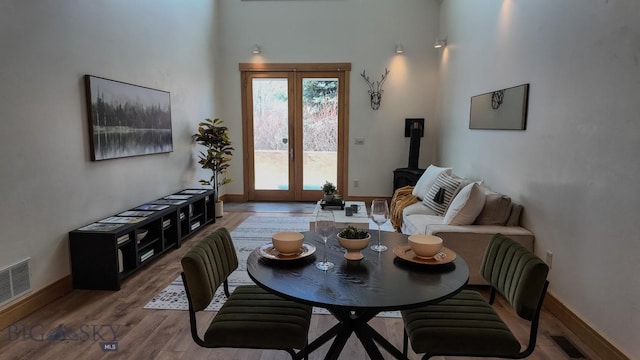 1281 Stoneridge Unit A, Bozeman, MT 59718 - living area featuring wood finished floors, a towering ceiling, and a wood stove
