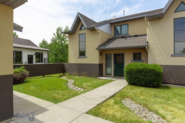 1281 Stoneridge Unit A, Bozeman, MT 59718 - view of front facade with stucco siding, a front lawn, and a shingled roof