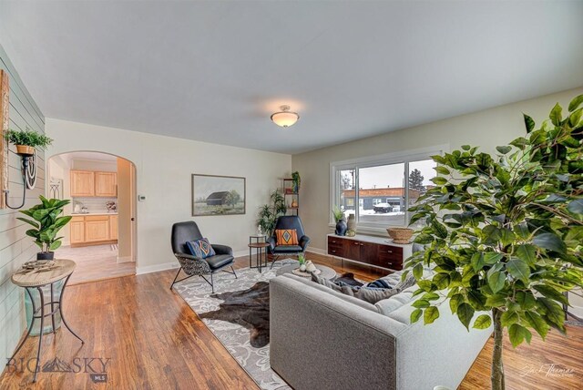 700 4th, Deer Lodge, MT 59722 - living room with light wood-style floors, baseboards, and arched walkways
