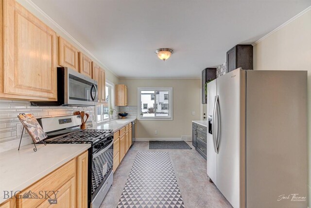 700 4th, Deer Lodge, MT 59722 - kitchen featuring appliances with stainless steel finishes, ornamental molding, decorative backsplash, and light brown cabinetry