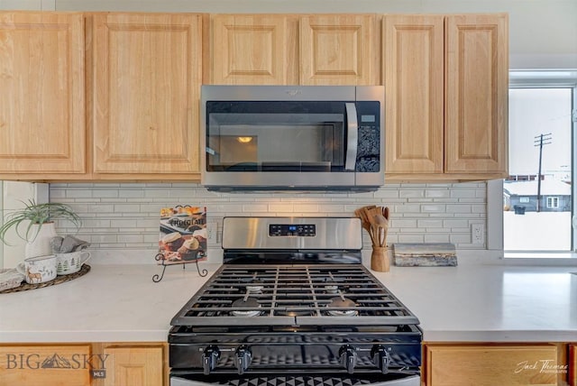 700 4th, Deer Lodge, MT 59722 - kitchen featuring light brown cabinets, stainless steel microwave, light countertops, and range with gas cooktop