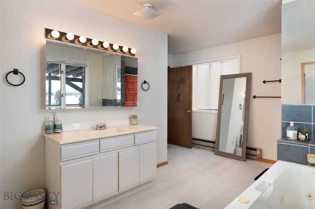 bathroom featuring a baseboard radiator, a tub with jets, a textured ceiling, vanity, and a baseboard heating unit