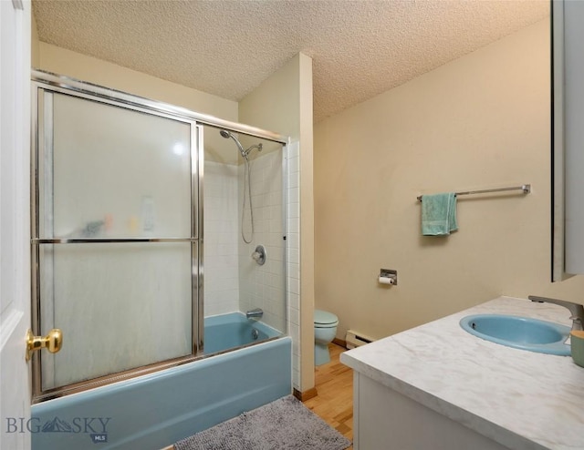 bathroom featuring toilet, baseboard heating, combined bath / shower with glass door, a textured ceiling, and wood finished floors