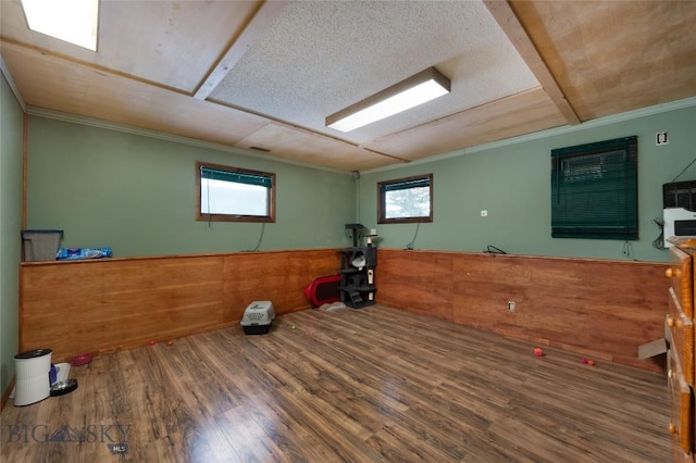 workout area with ornamental molding and wood finished floors