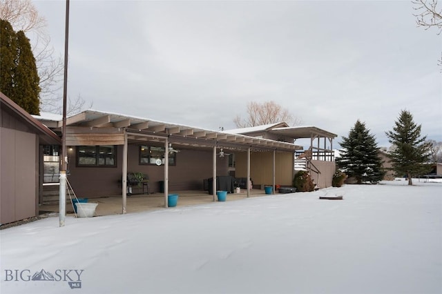 snow covered house with a patio area