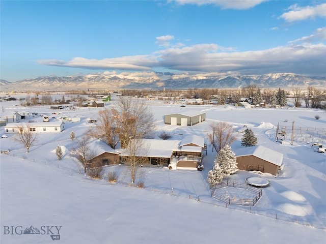 snowy aerial view featuring a mountain view