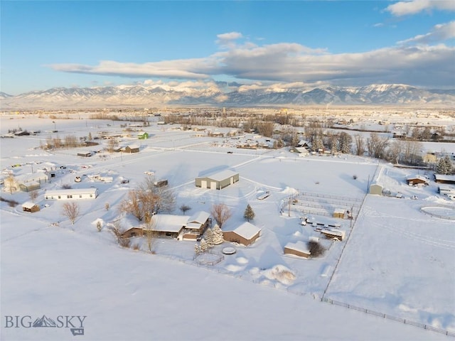 snowy aerial view featuring a mountain view