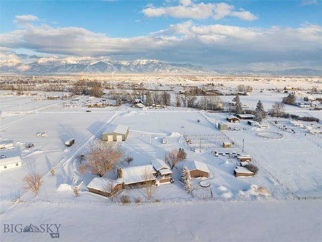 snowy aerial view with a mountain view