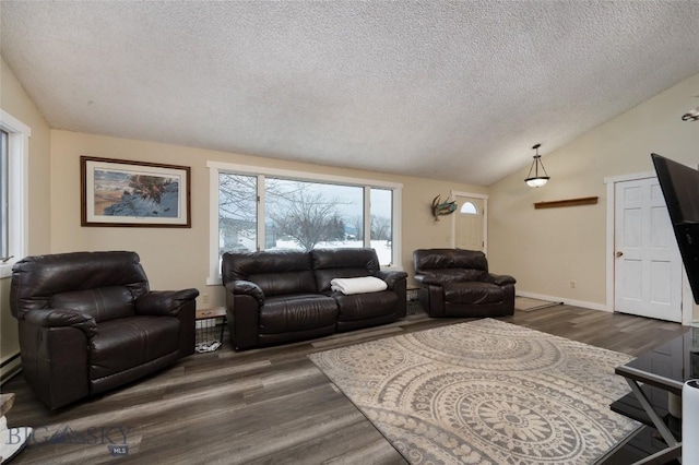 living room with vaulted ceiling, a textured ceiling, wood finished floors, and baseboards