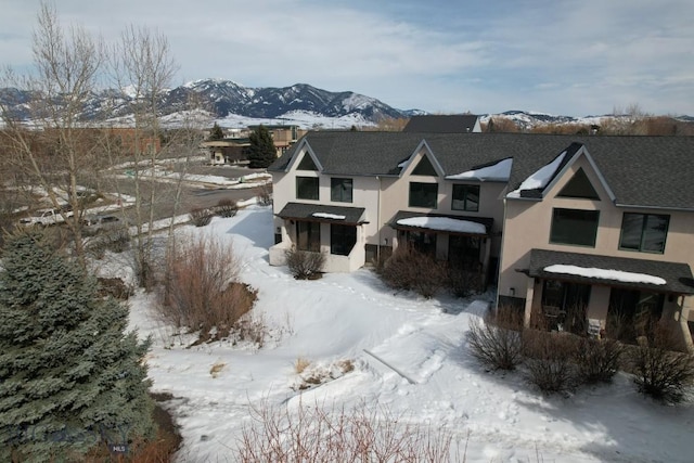 exterior space with a mountain view and stucco siding