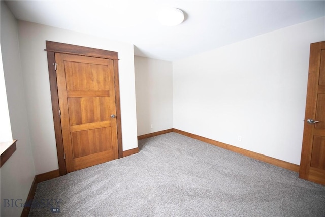 unfurnished bedroom with carpet and baseboards