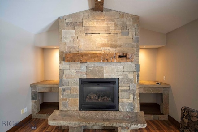 interior details featuring a stone fireplace, baseboards, and wood finished floors